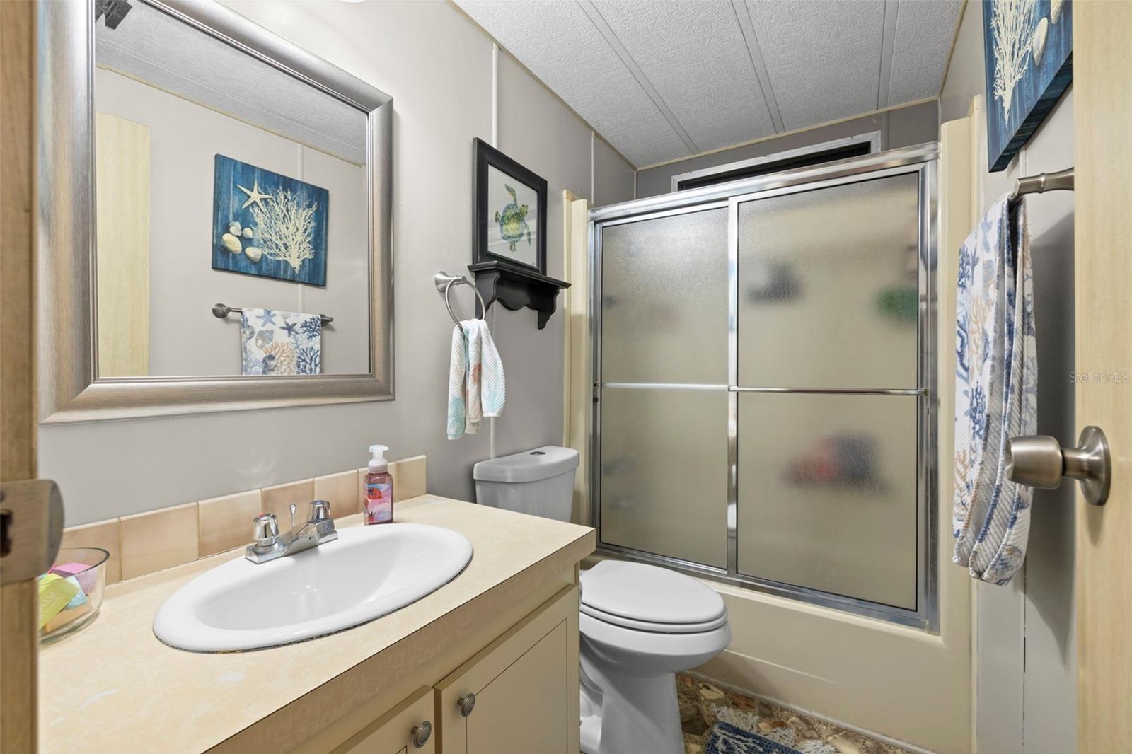 Full guest bathroom with shower/tub combo, comfort height toilet, new vanity mirror and fresh paint!