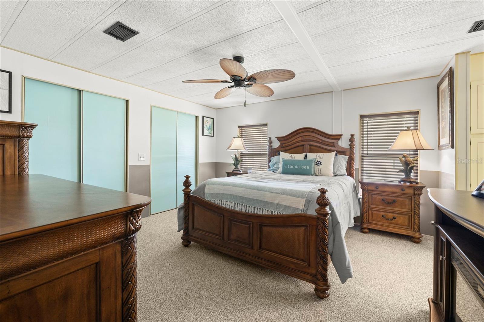 Large primary suite with dual closets, ceiling fan and ensuite bathroom