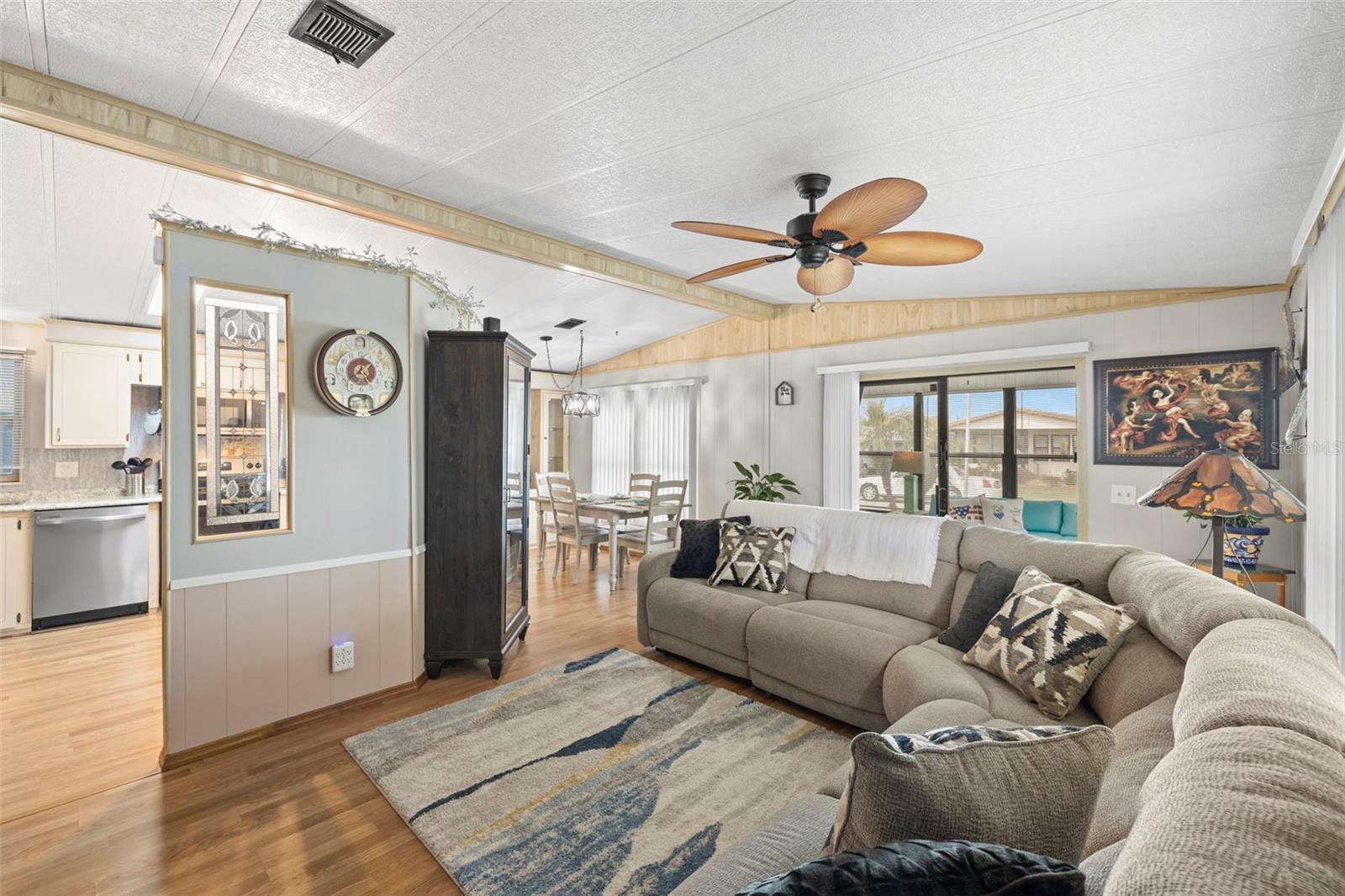 Large living room with lvp flooring, new ceiling fan and fresh paint!