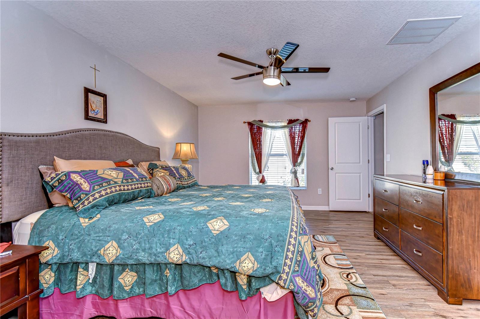 Spacious primary bedroom with natural light.