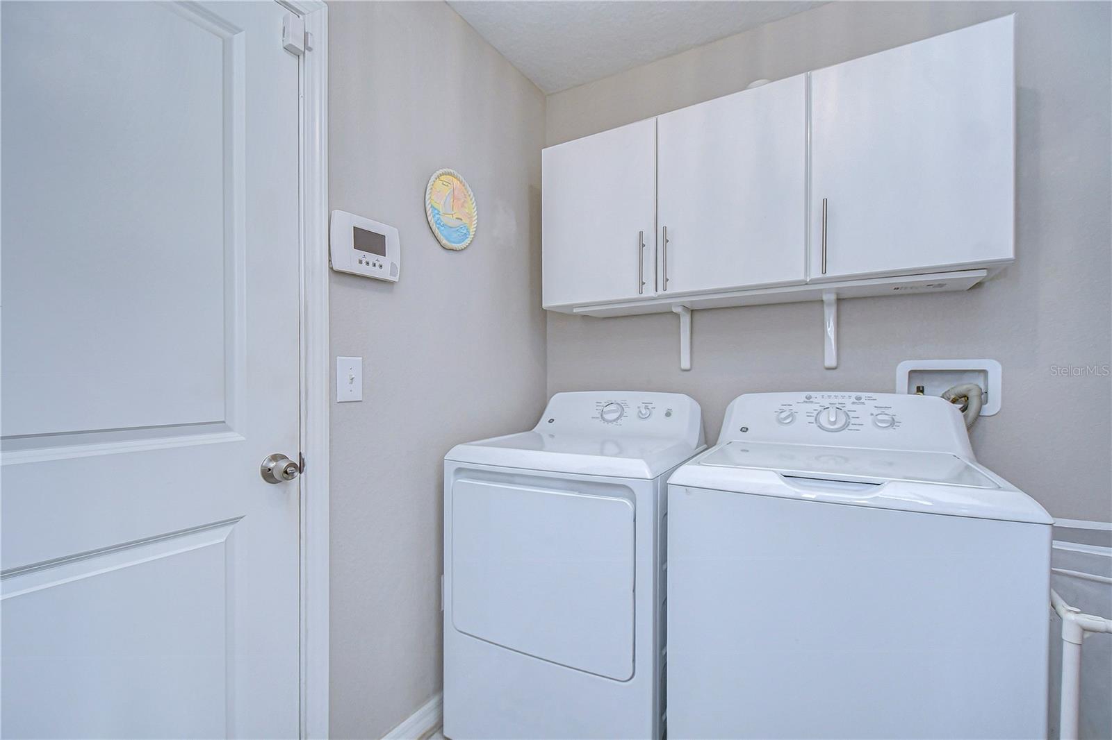 Convenient laundry space with storage.