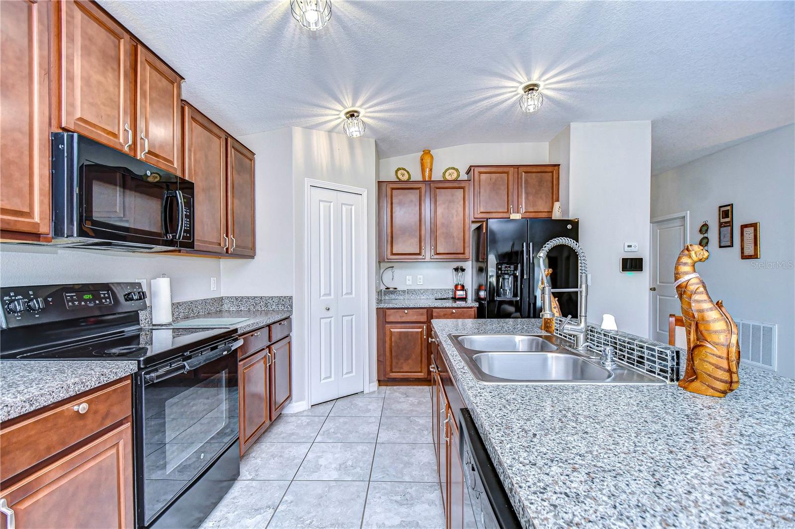 Large kitchen with sleek countertops.