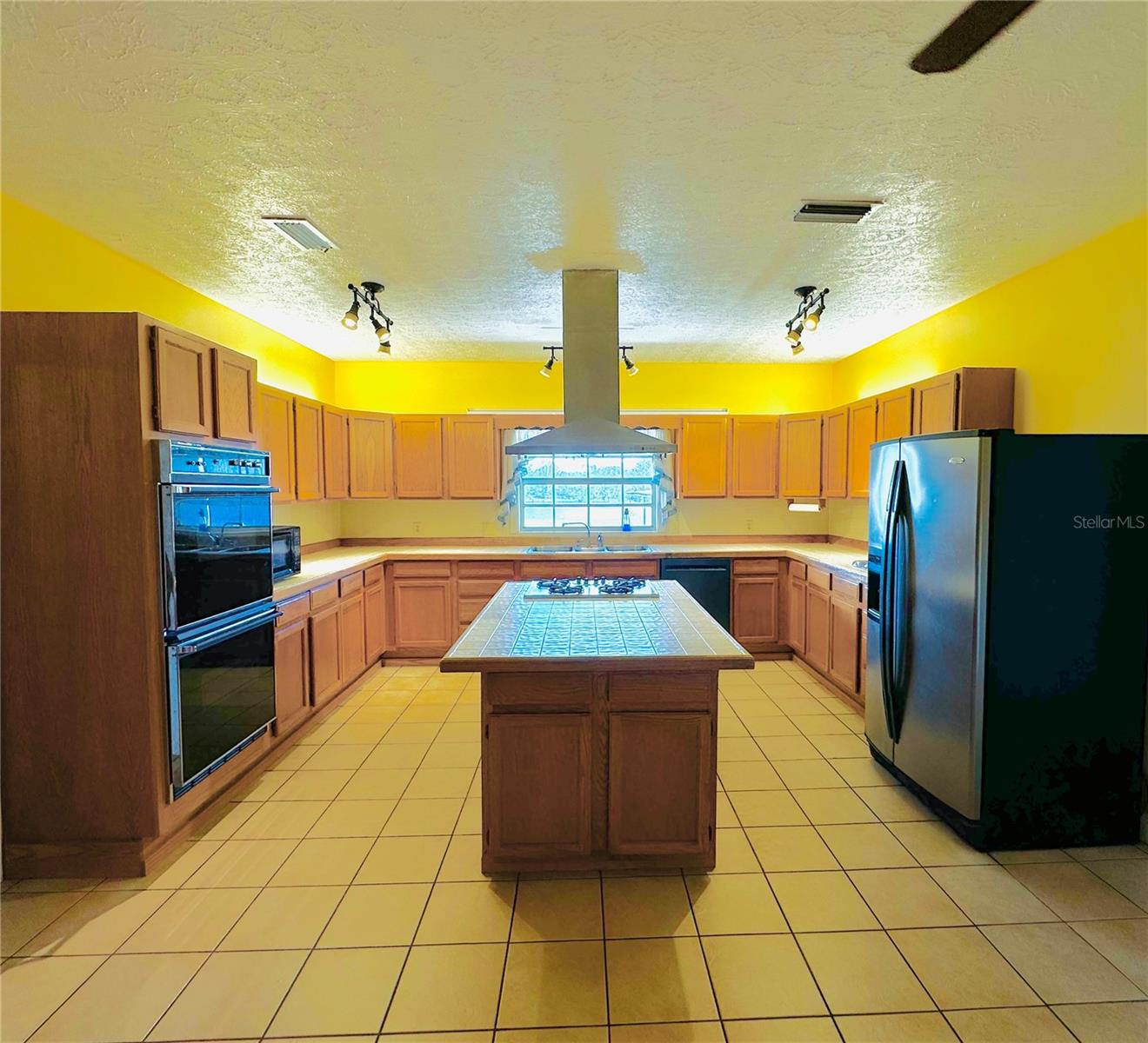 Kitchen with Double ovens, gas cooktop, and range hood