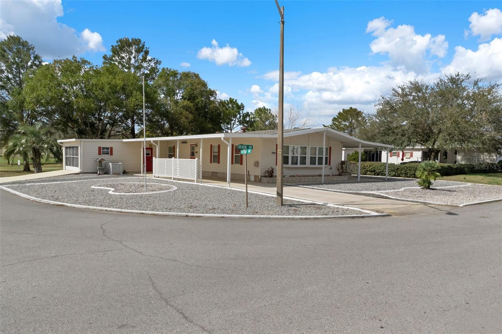 Corner Lot on golf course.  You have 2 car garage and a 2 car carport which could be used to screen in for a screen room.  Another porch on the right side too.  Perfect for outdoor plants