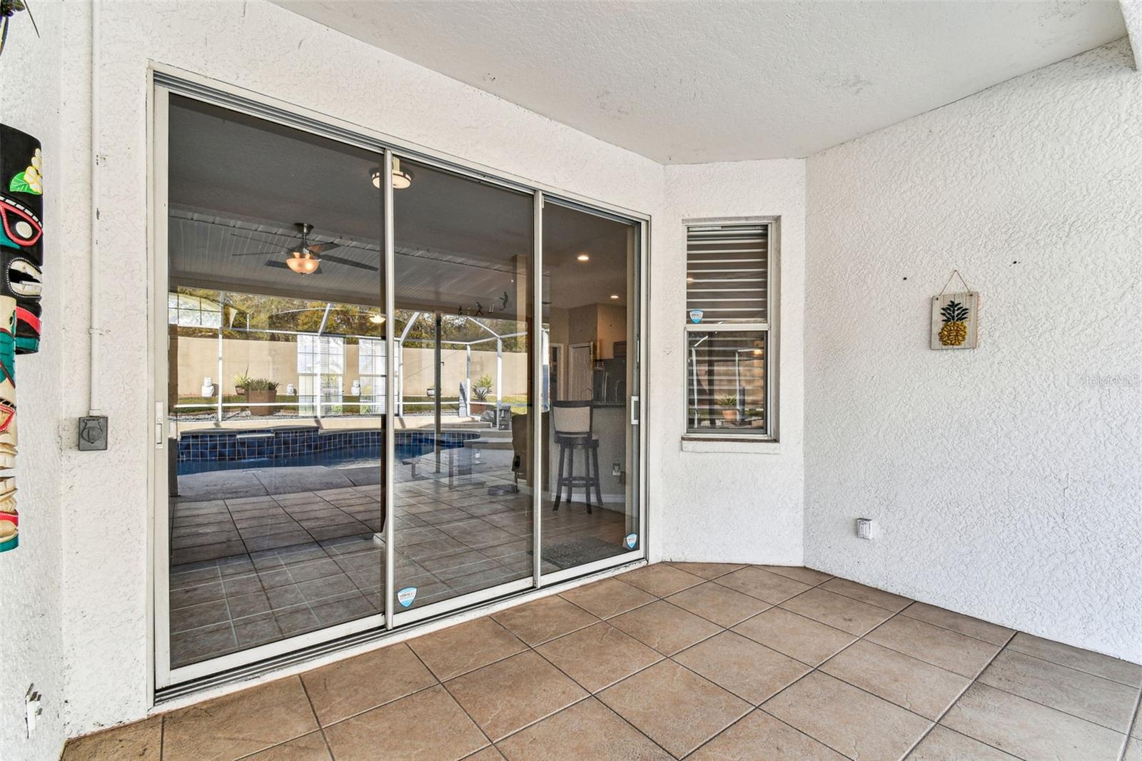 Sliders from the living room to the covered patio area.