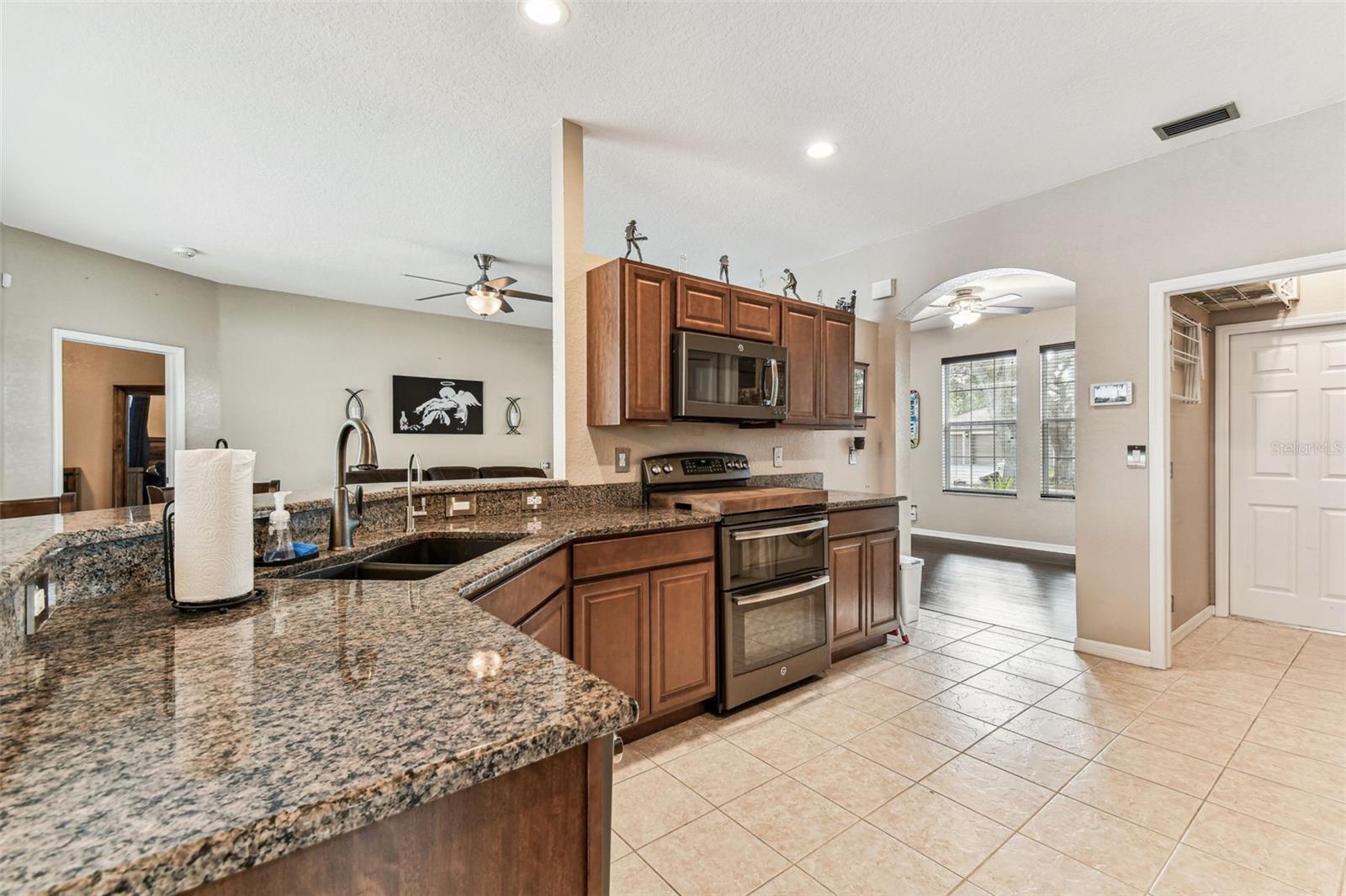 Gleaming granite counters open to the living room. Double oven and micro hood.