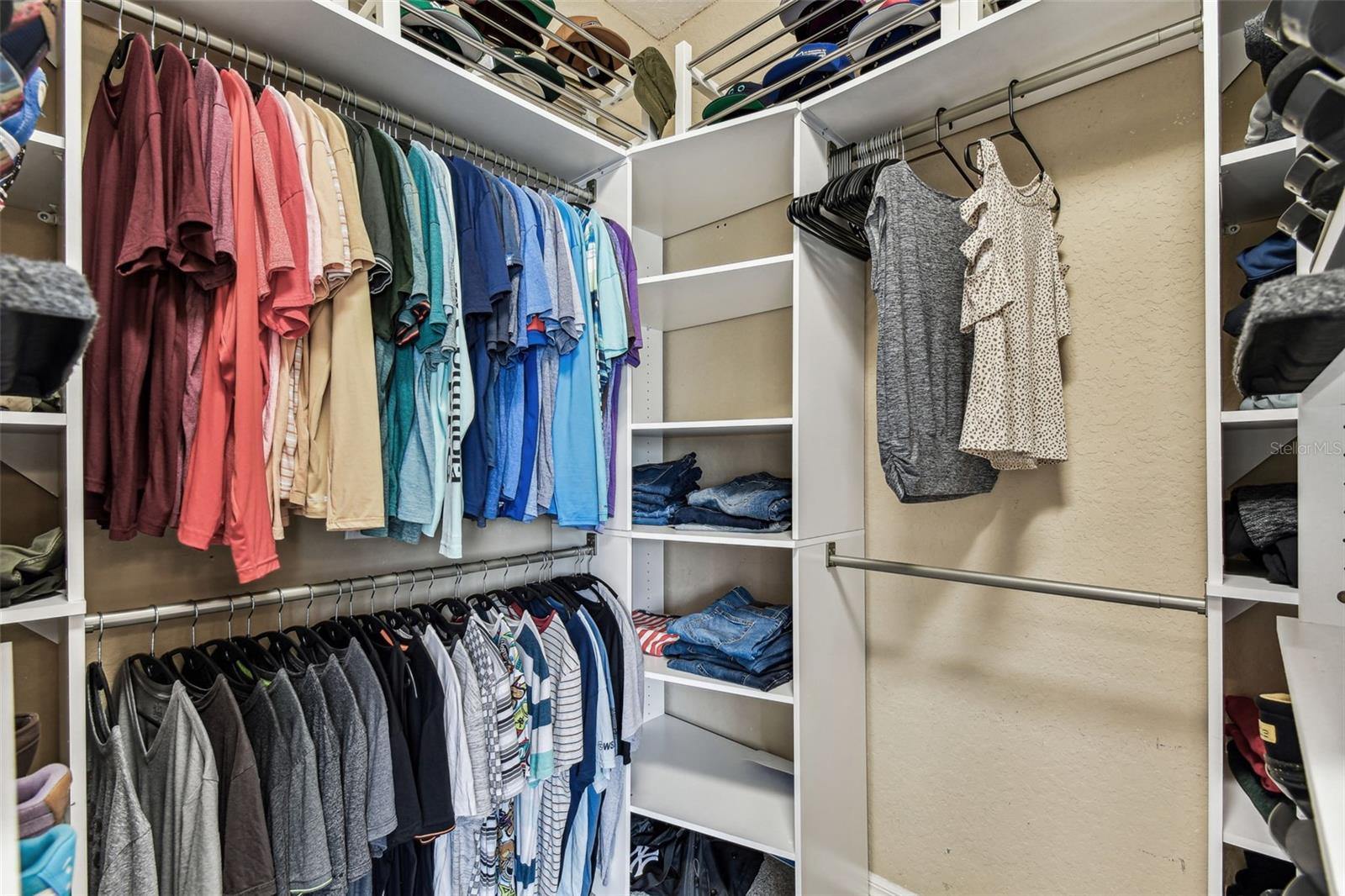 Large walk-in primary closet with built-ins.