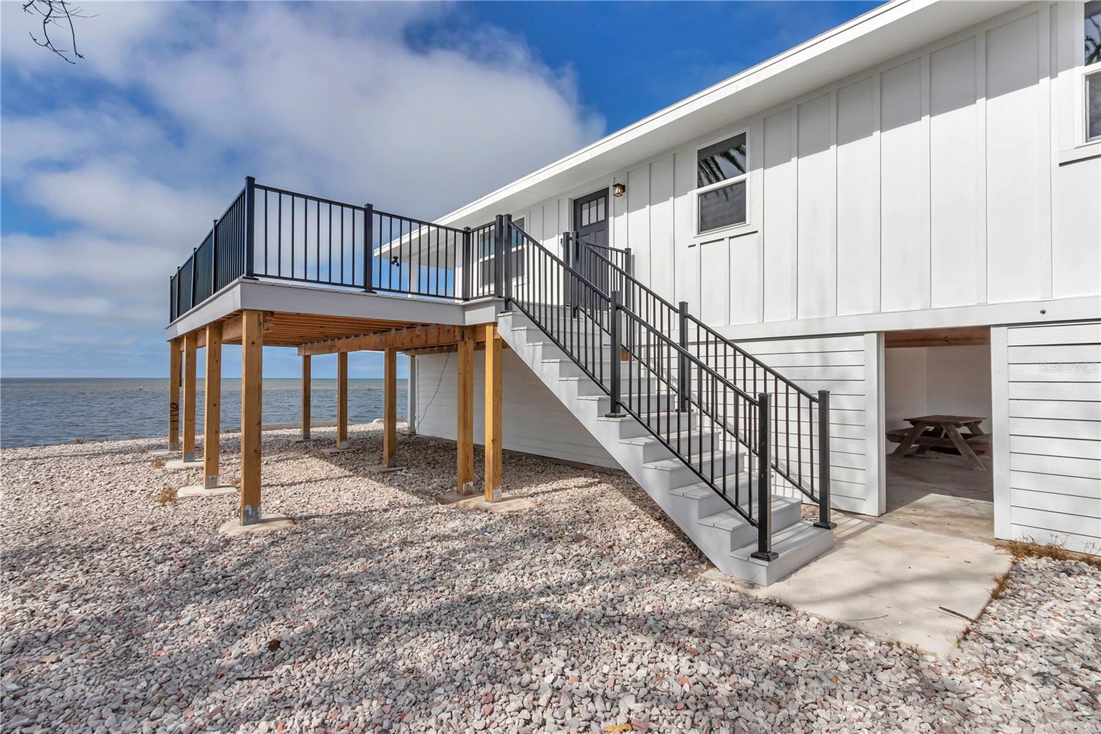 Wrap around porch with Black metal modern rail