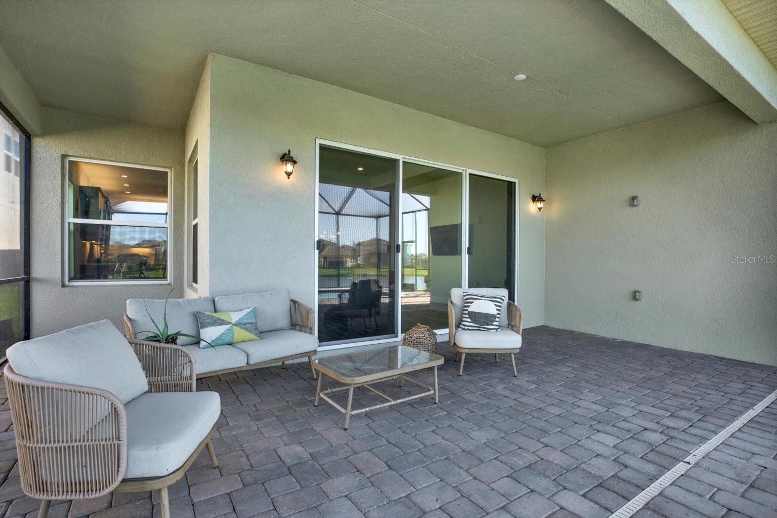 Paved outdoor lanai with pool