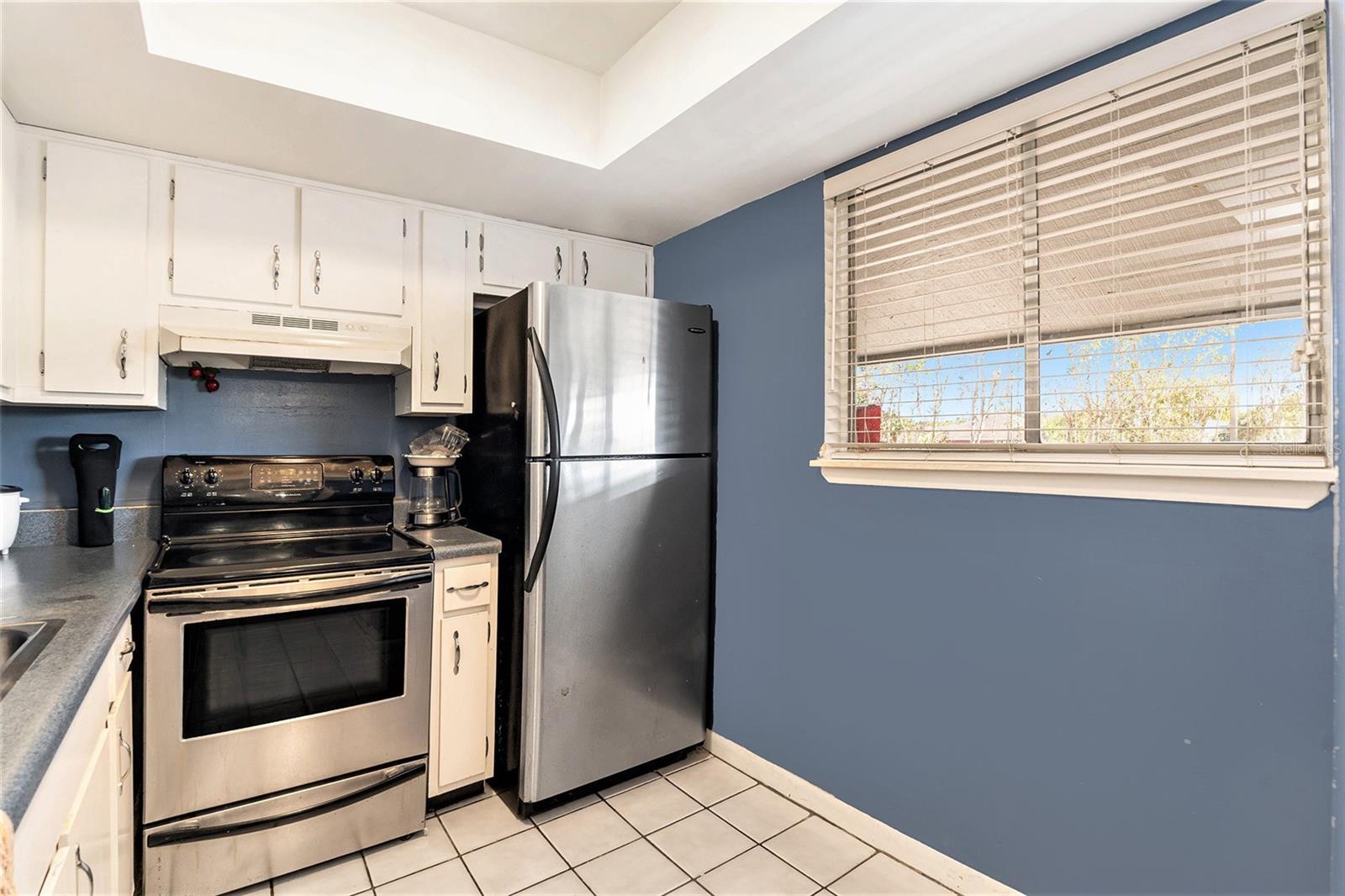 The kitchen boasts updated cabinets and stainless steel appliances.