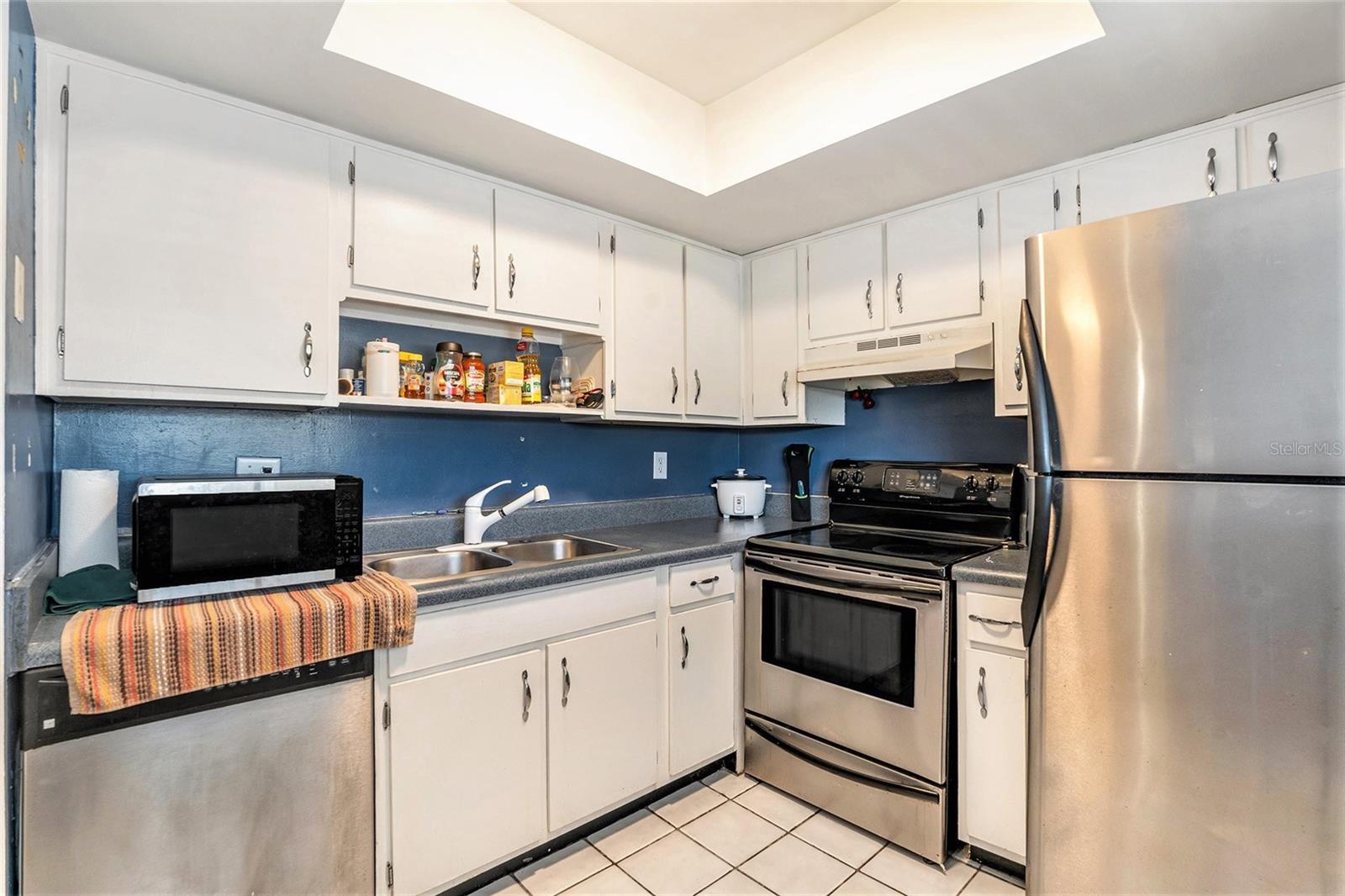 The kitchen boasts updated cabinets and stainless steel appliances.