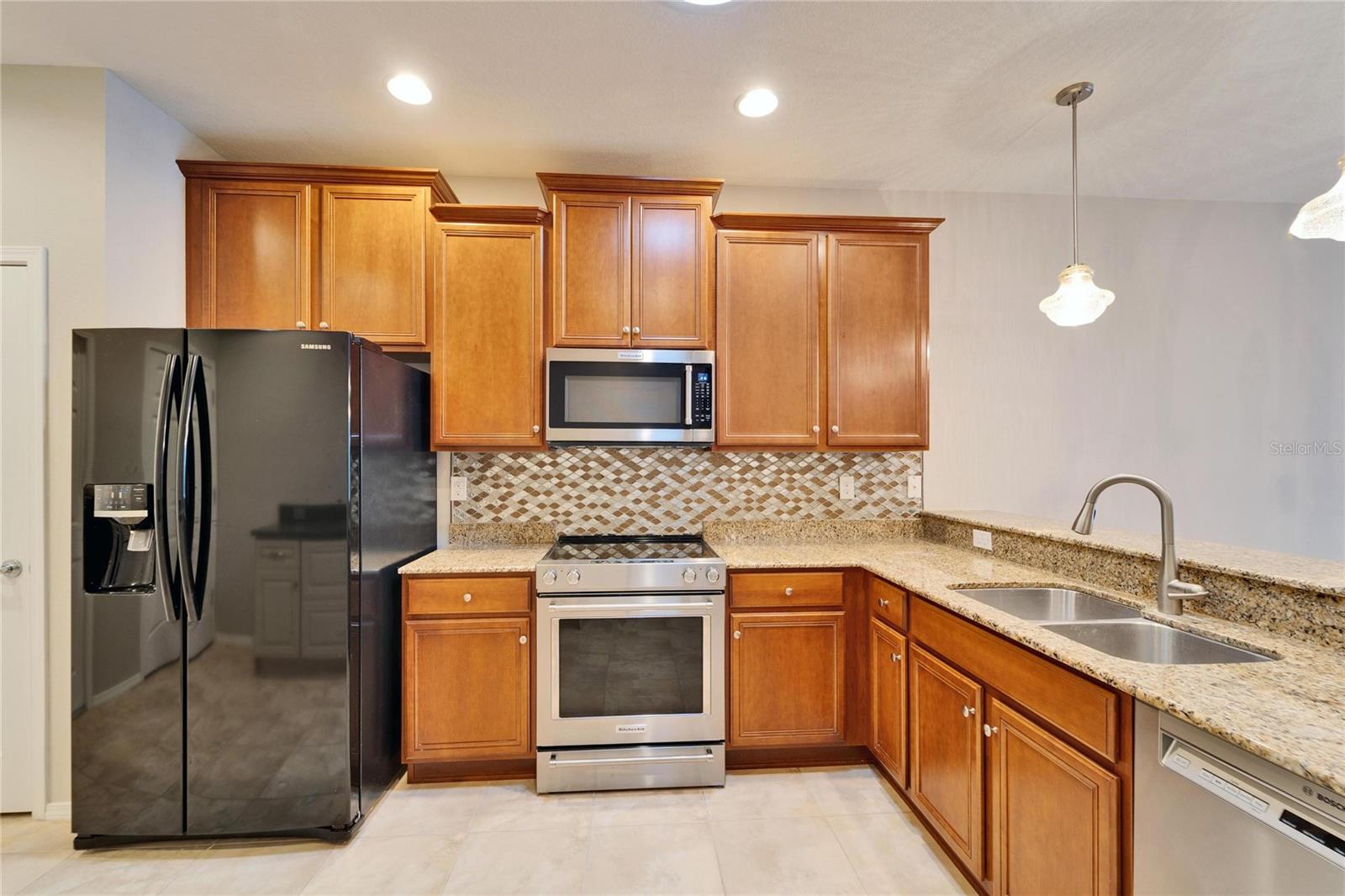 Kitchen with view of sink and brekfast bar.