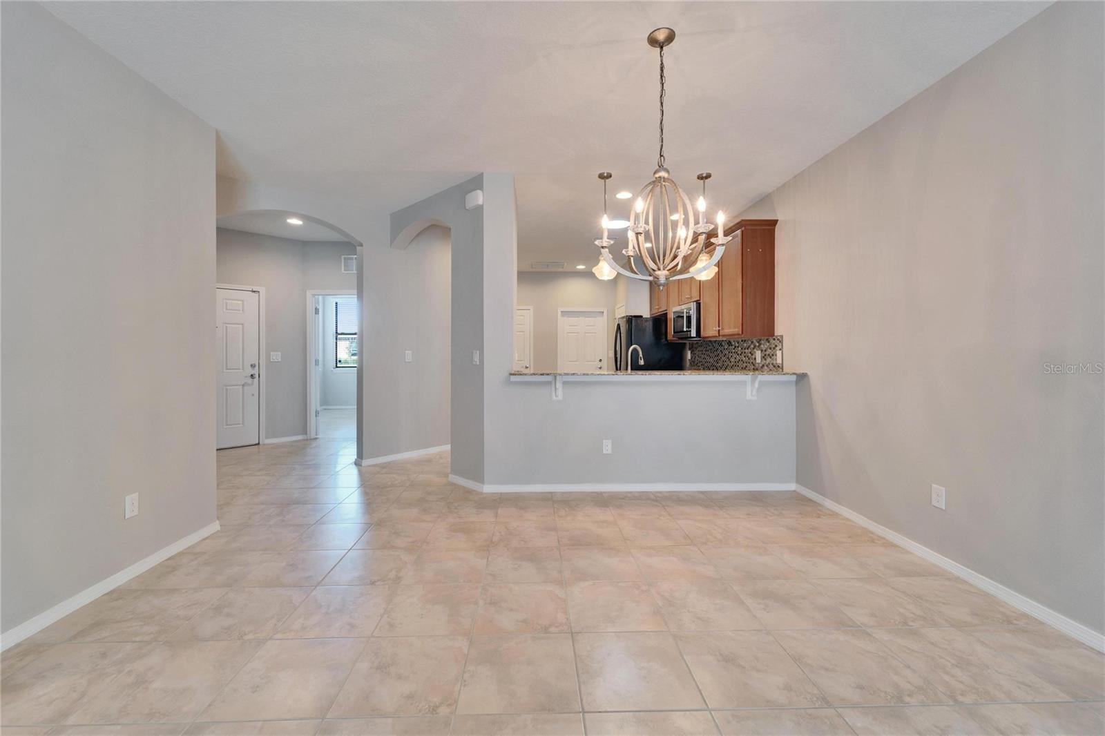 Looking through greatroom/dining room into kitchen from sliding doors.