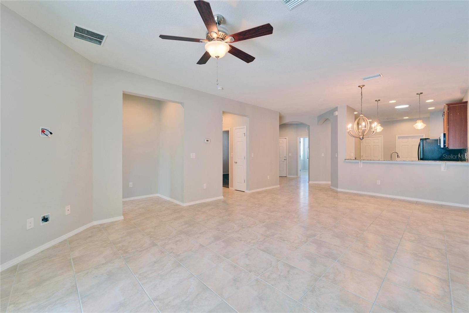 Looking in from the sliders to lanai, the great room and dining room are ahead. The owners suite is on the left, the guest suite is next, then the front hall with office with the kitchen on the right.