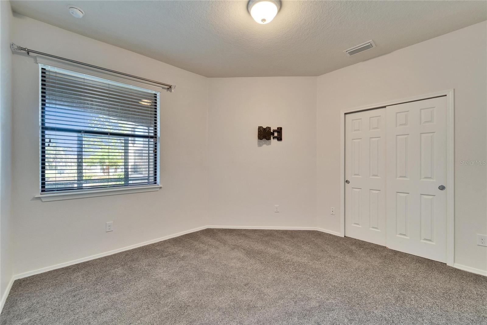 Guest bedroom with brand new carpeting.