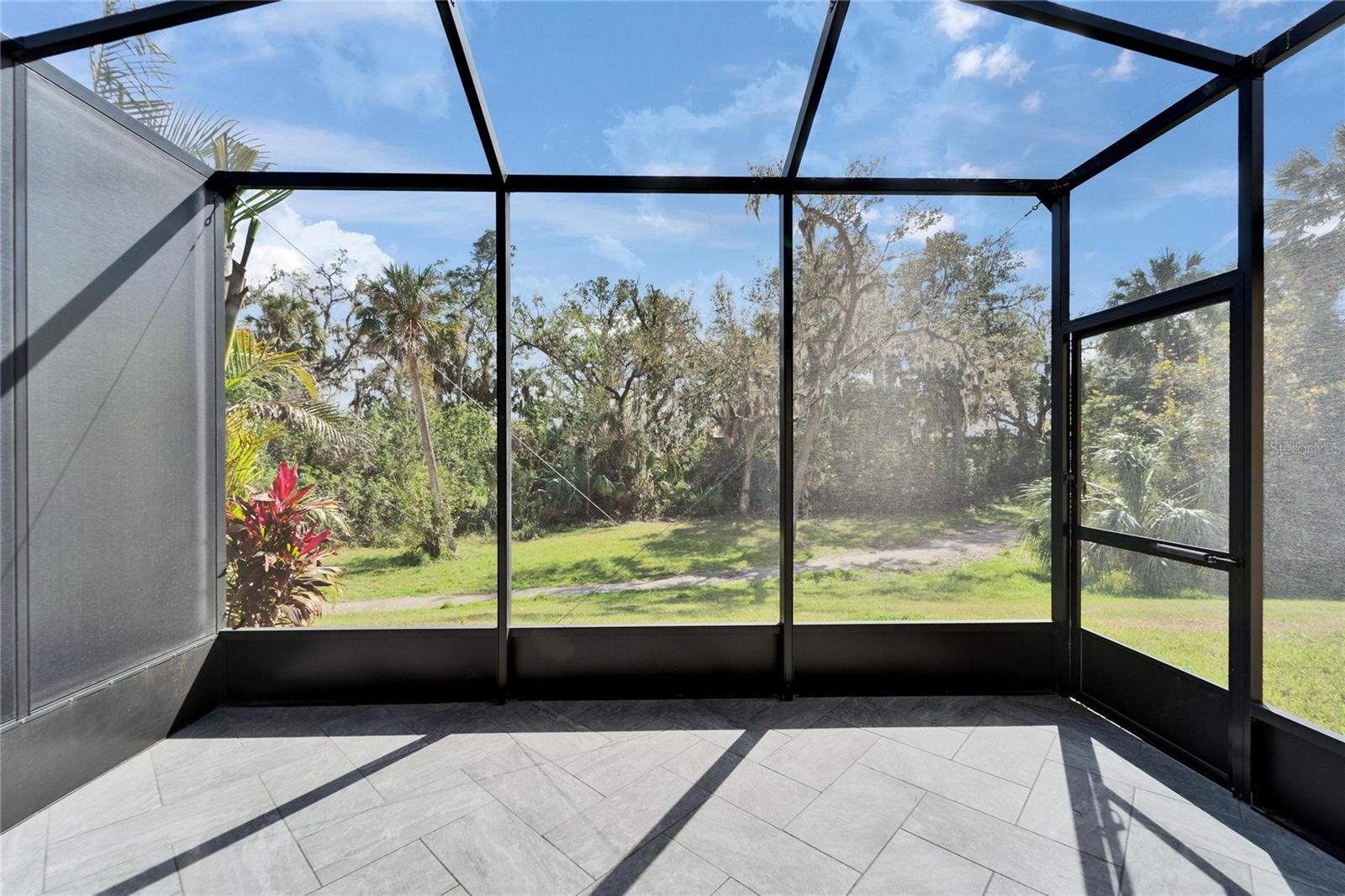 Extended lanai overlooking nature path.