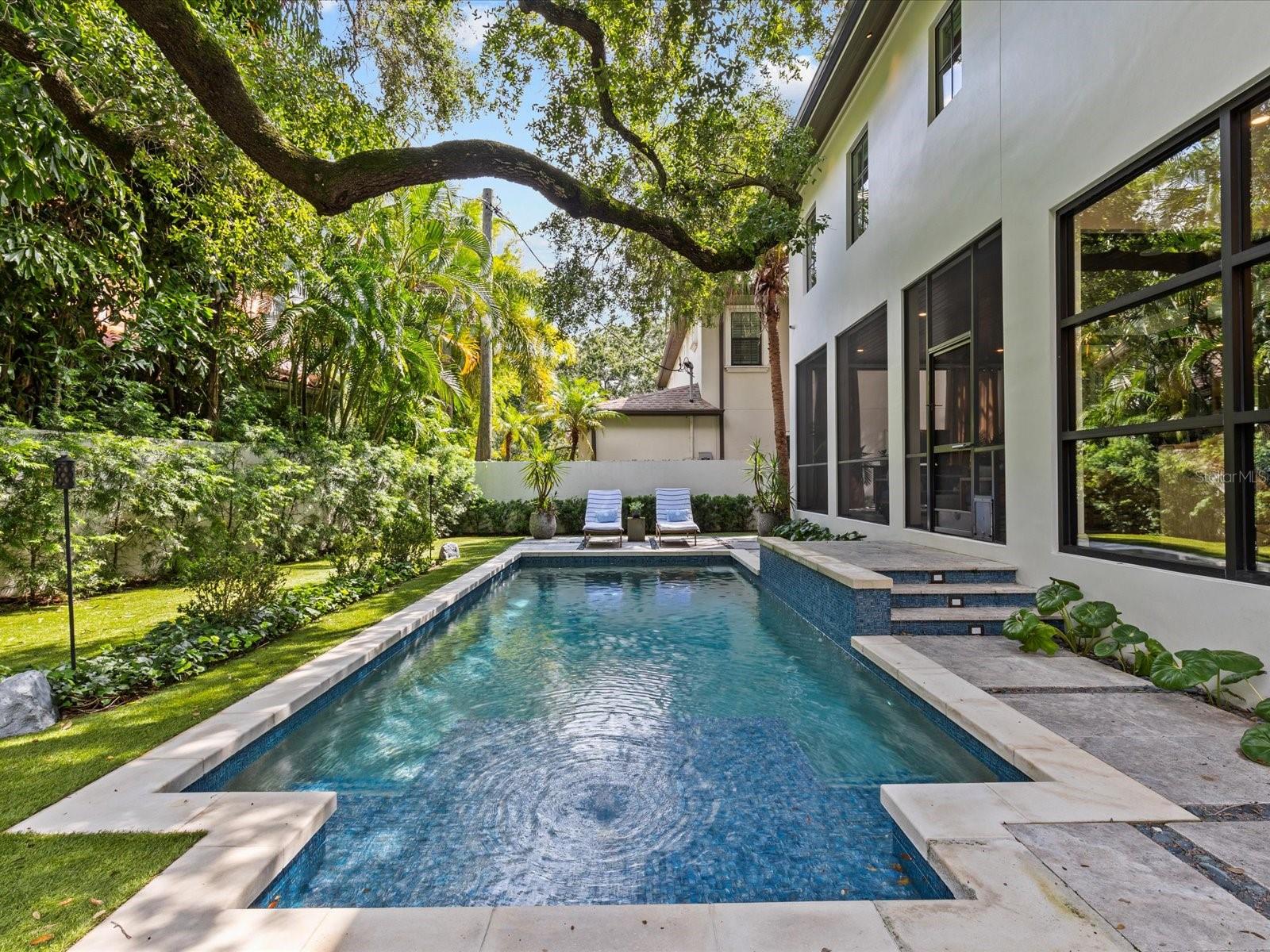 7'-8' deep swimming pool with sun shelf, bubbler and fountain sprays.