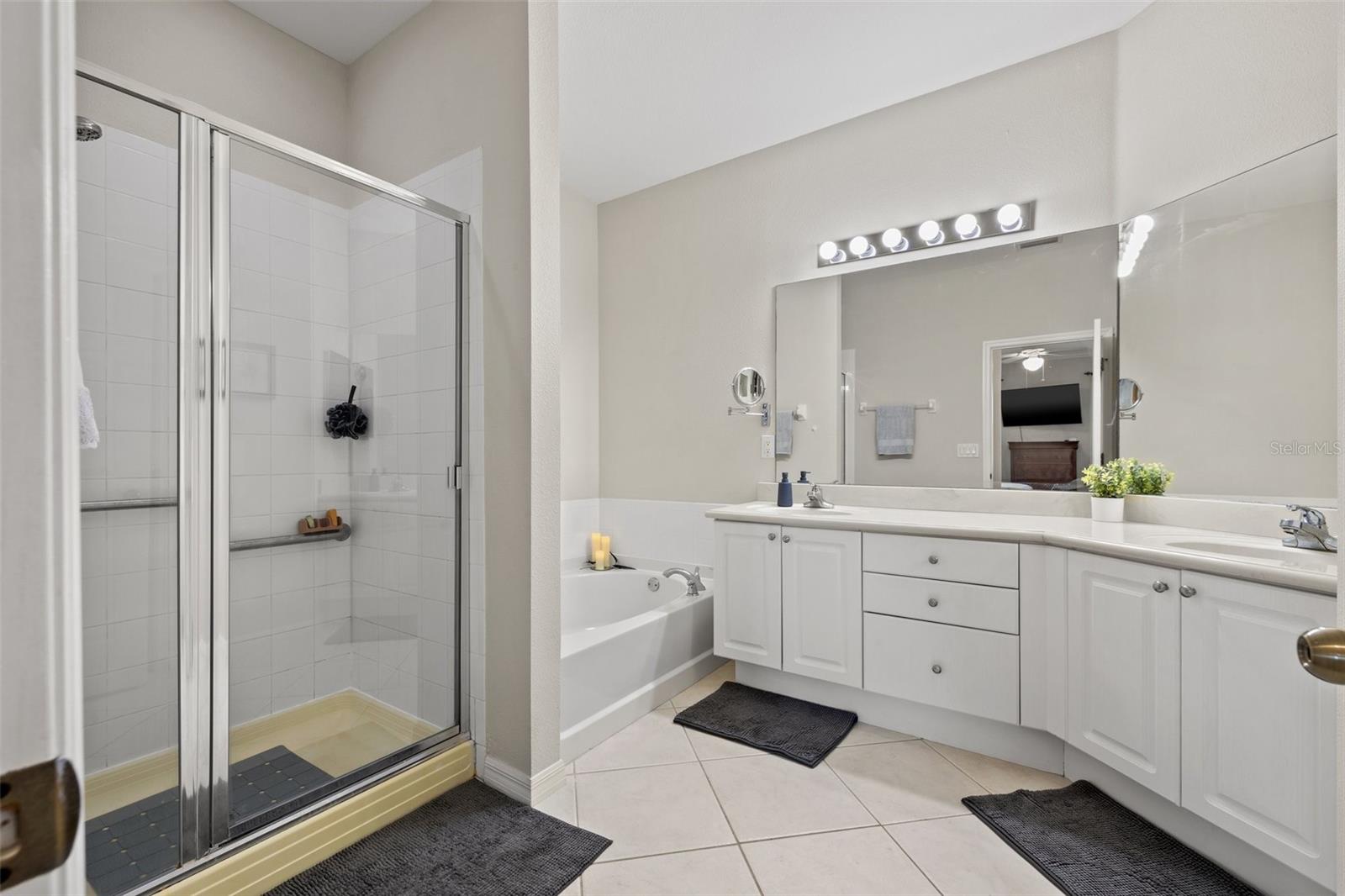 Spacious primary en-suite with walk-in shower and soaking tub.