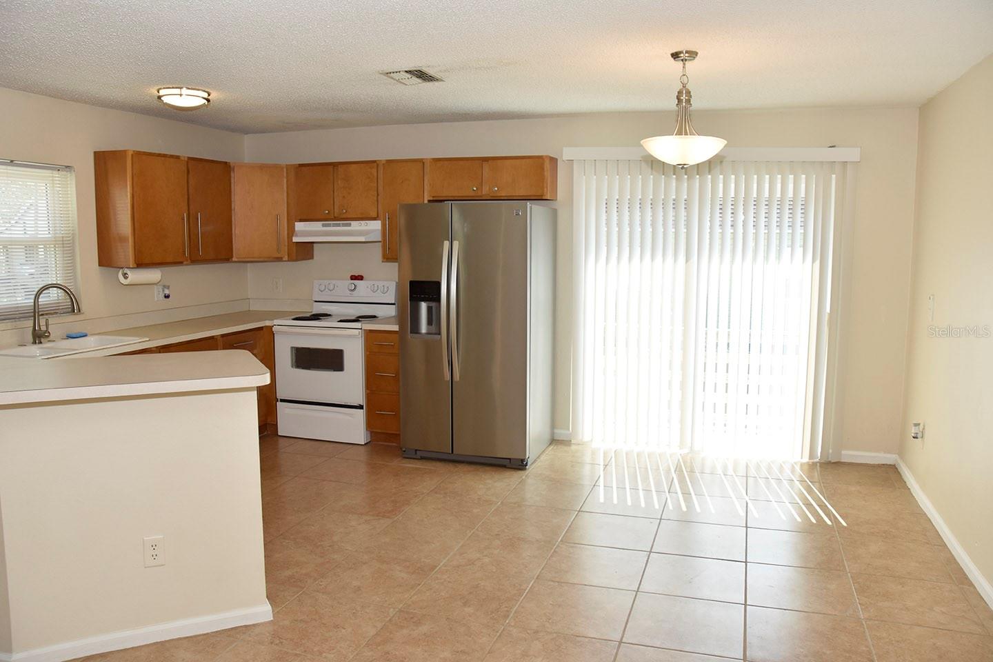 Eat-in area adjacent to the kitchen has sliders to the side porch and yard.