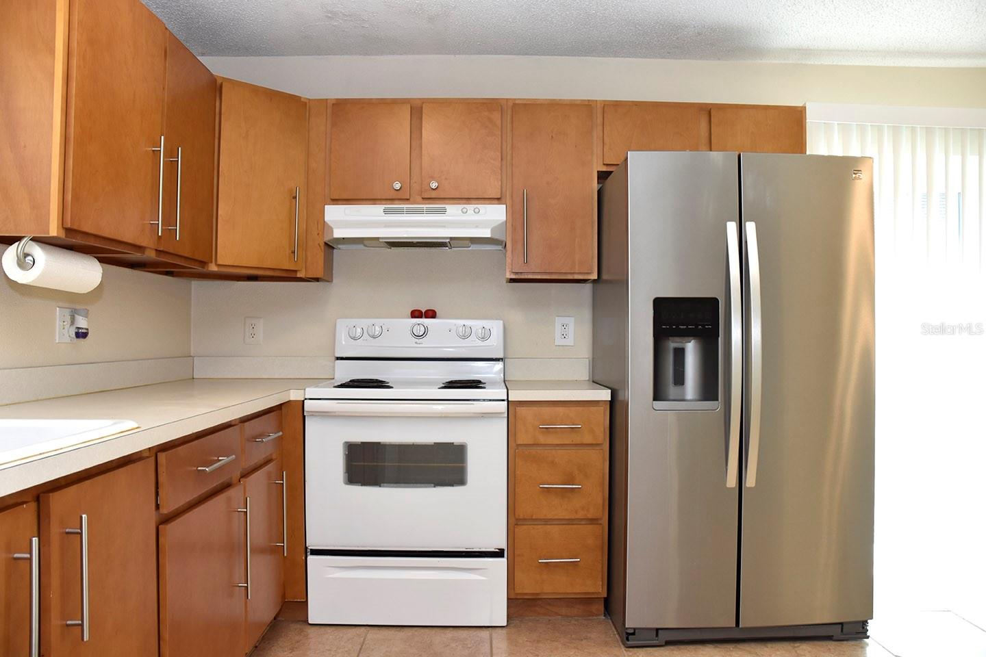 Kitchen with wood cabinets and lots of storage.