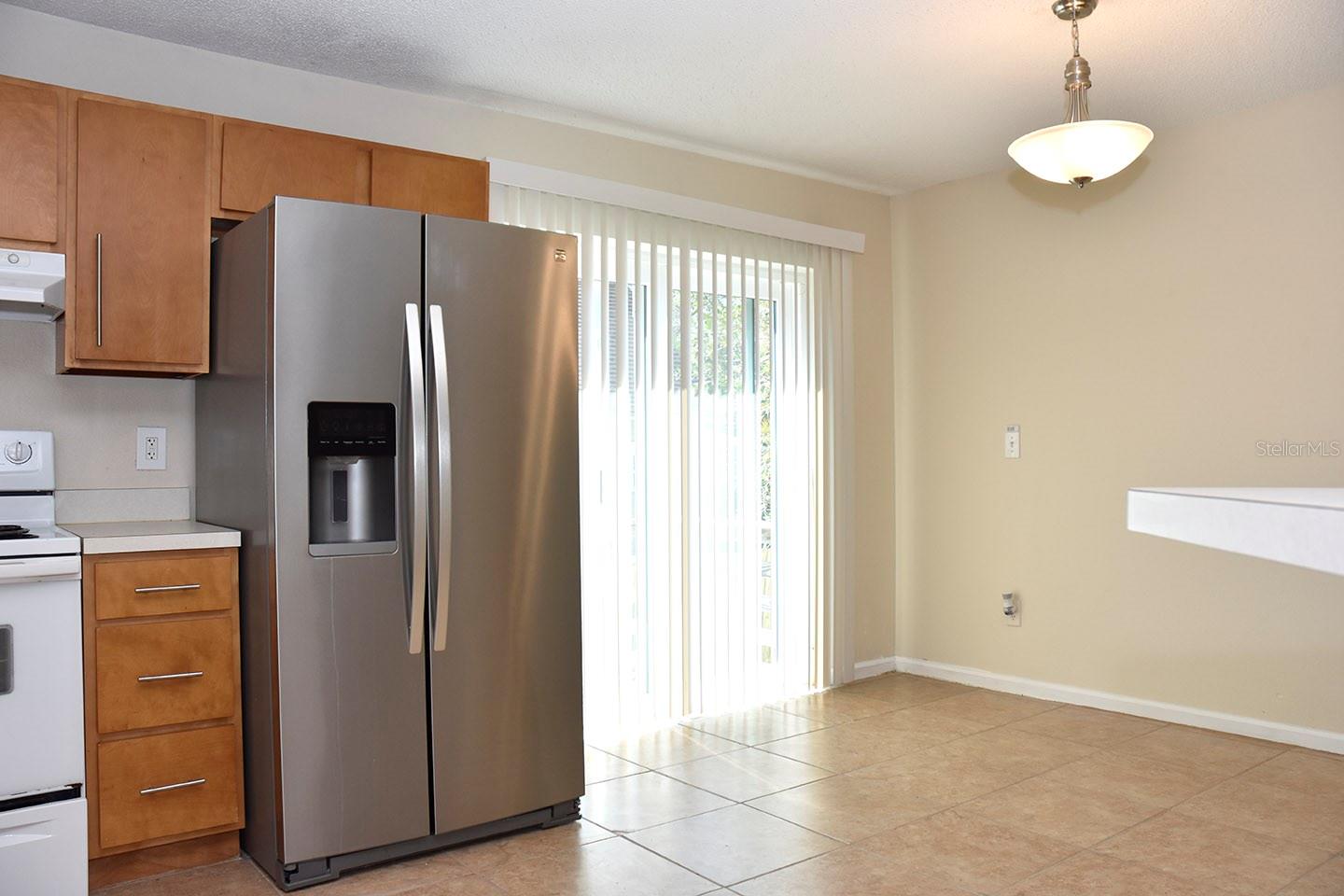 New stainless steel refrigerator and new sliders to the side porch.