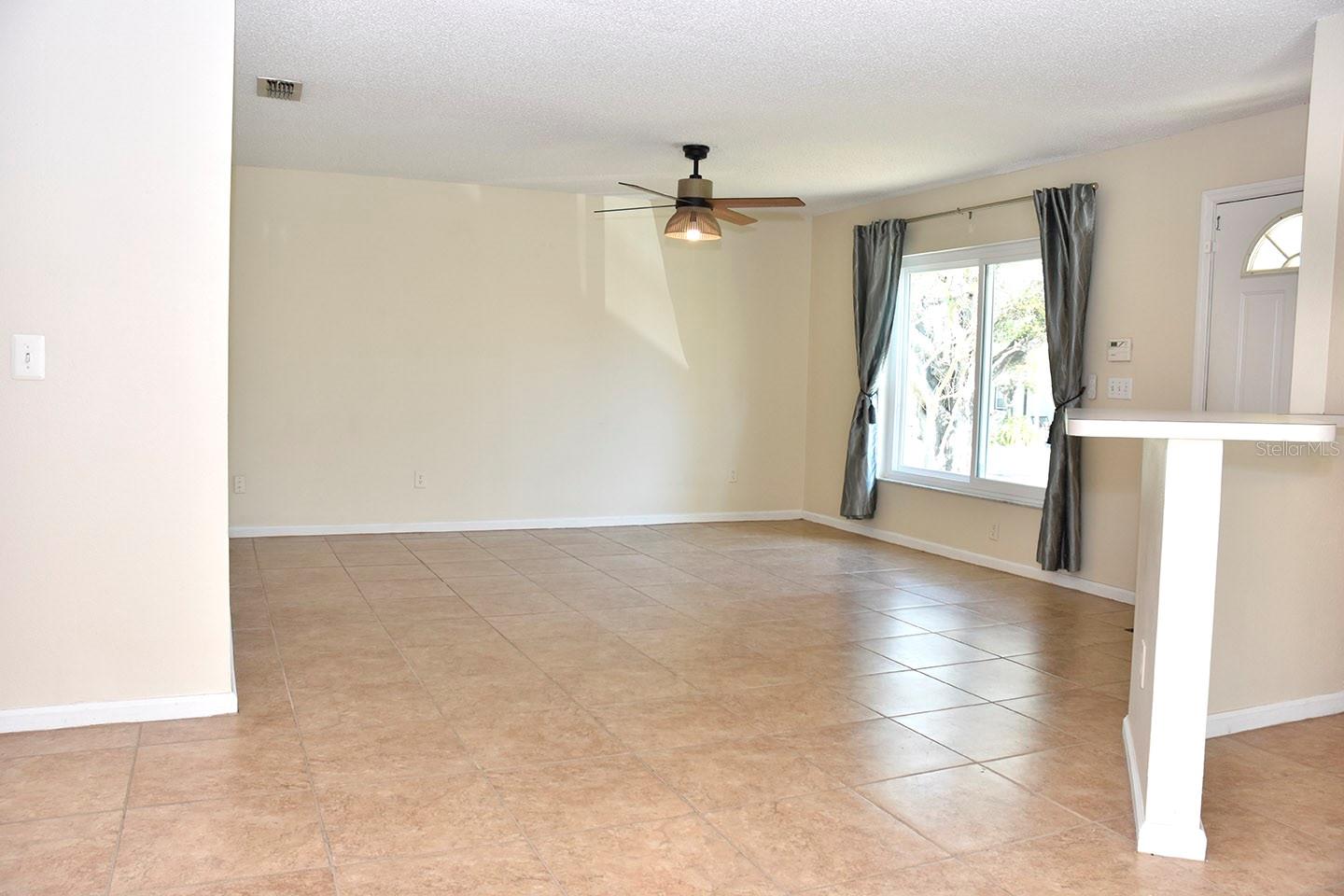 Living room with new window and new ceiling fan.