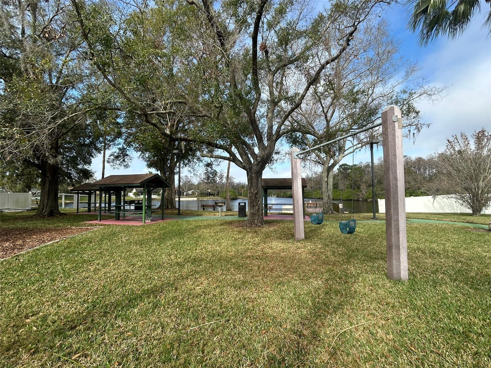 Lakefront park with a playground, pier, swimming pool, and tennis, basketball and racquetball courts!