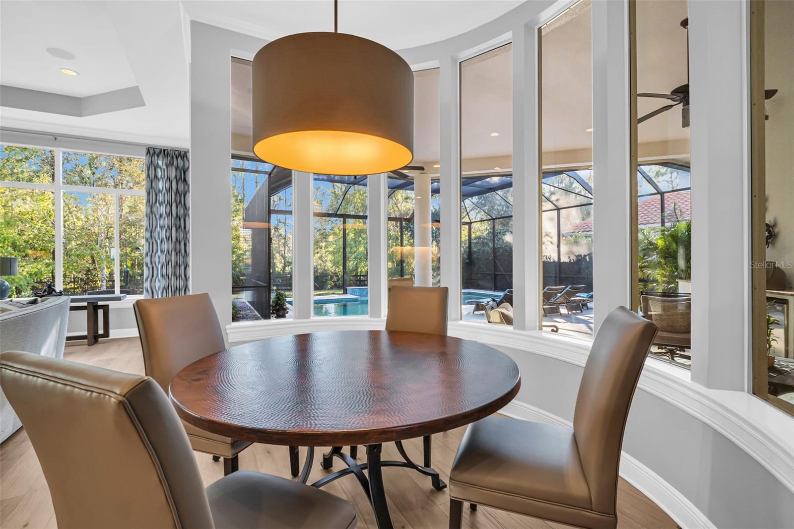 Kitchen breakfast area with view of patio and pool area