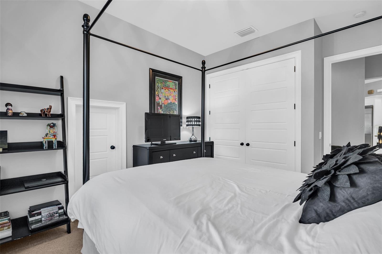 3rd Bedroom with double door closet and a storage area that leads under the steps.