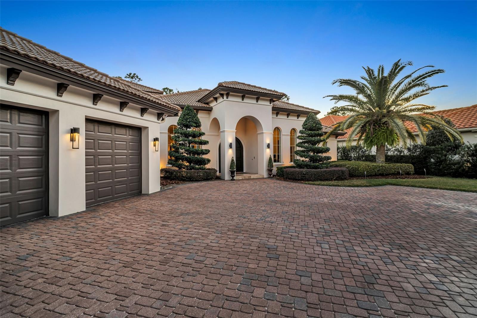 Front view of house with large paver driveway