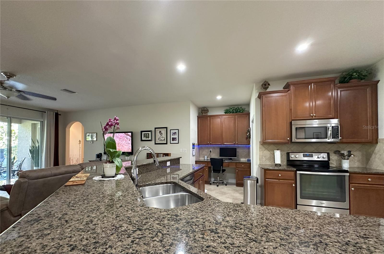 Granite kitchen countertop and view of built-in desk