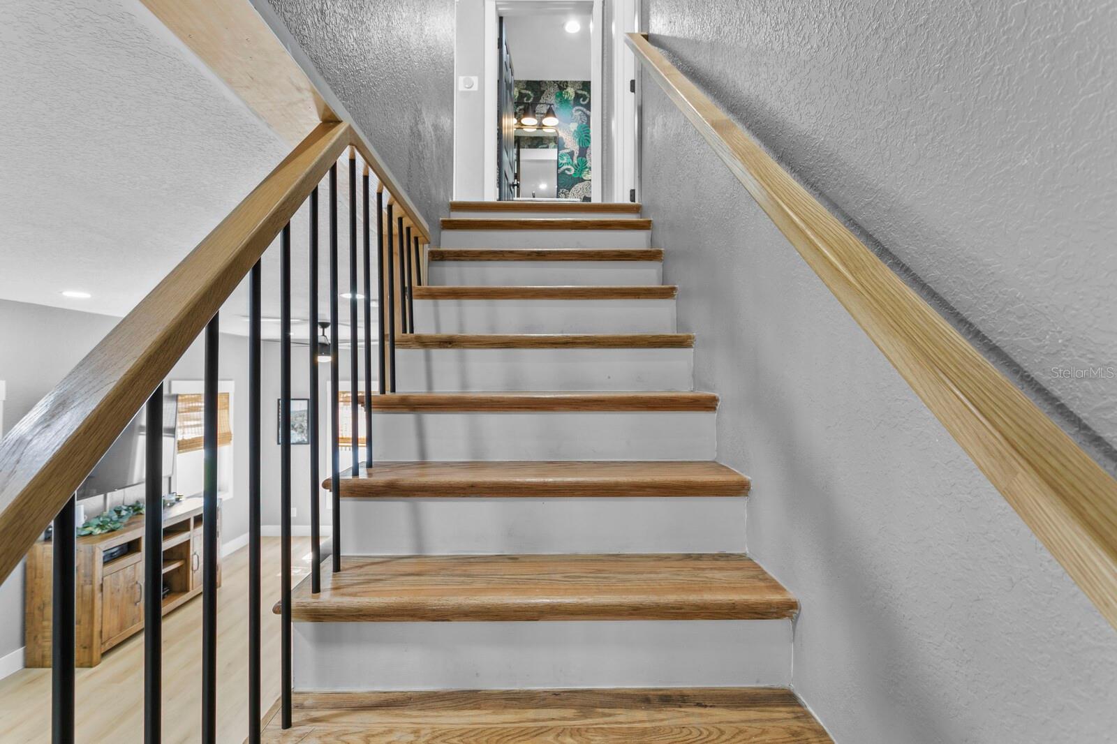 The solid wood stairs include a new custom handrail