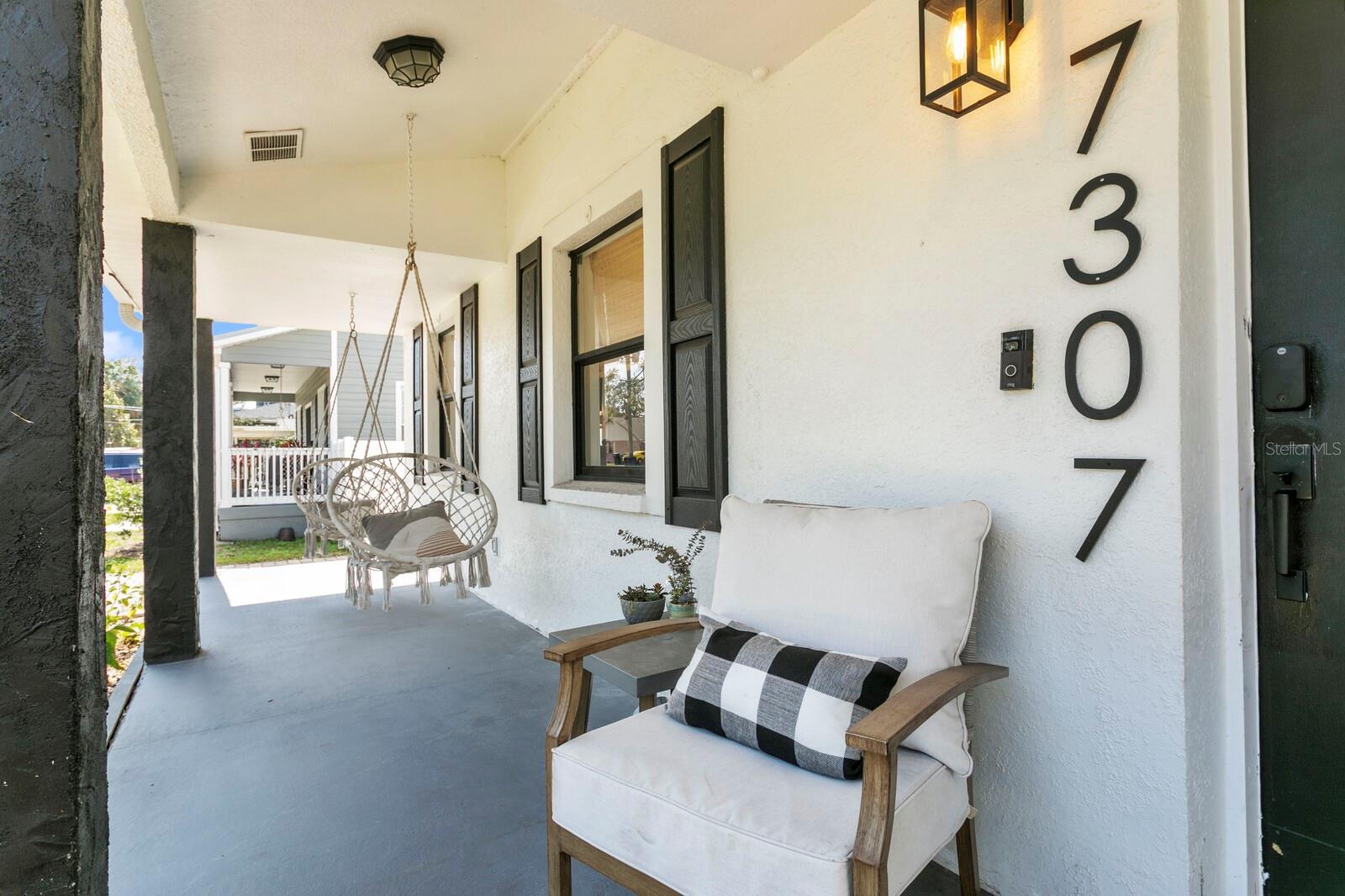 The welcoming front porch spans the entire width of the home