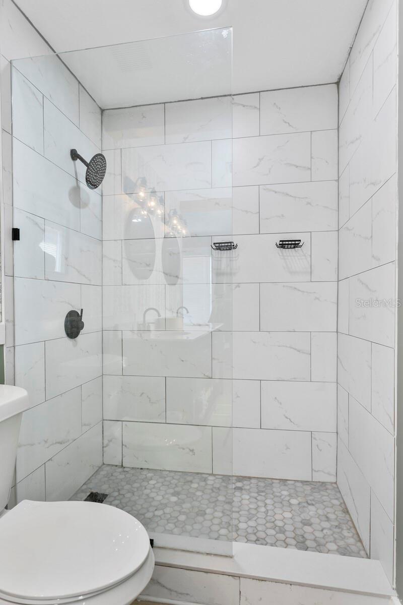 The framless walk-in shower include a rain shower head