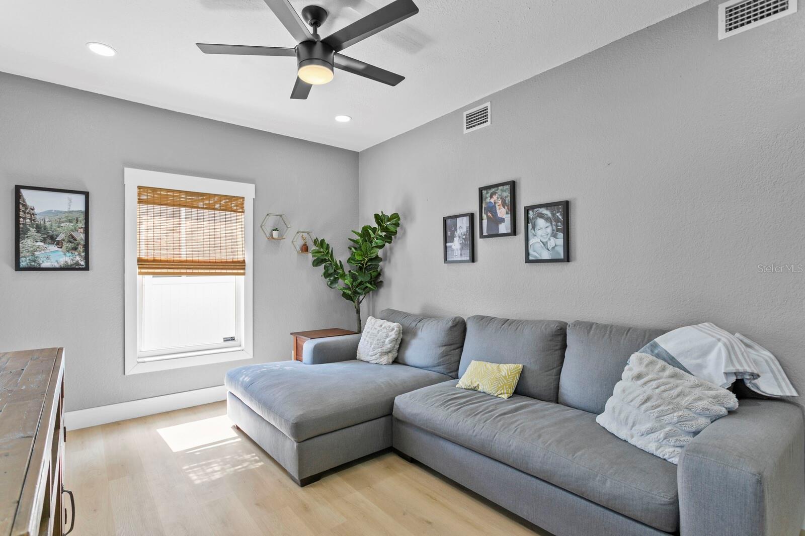 The family room includes recessed LED lighting and a ceiling fan