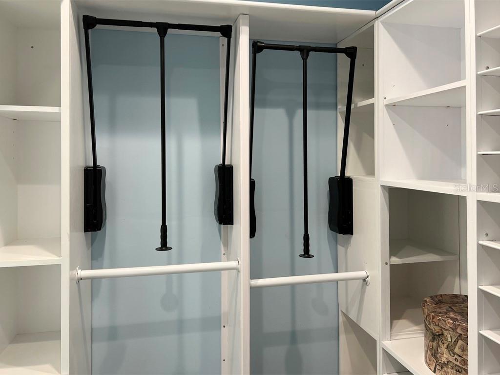 Storage with pull down closet rods