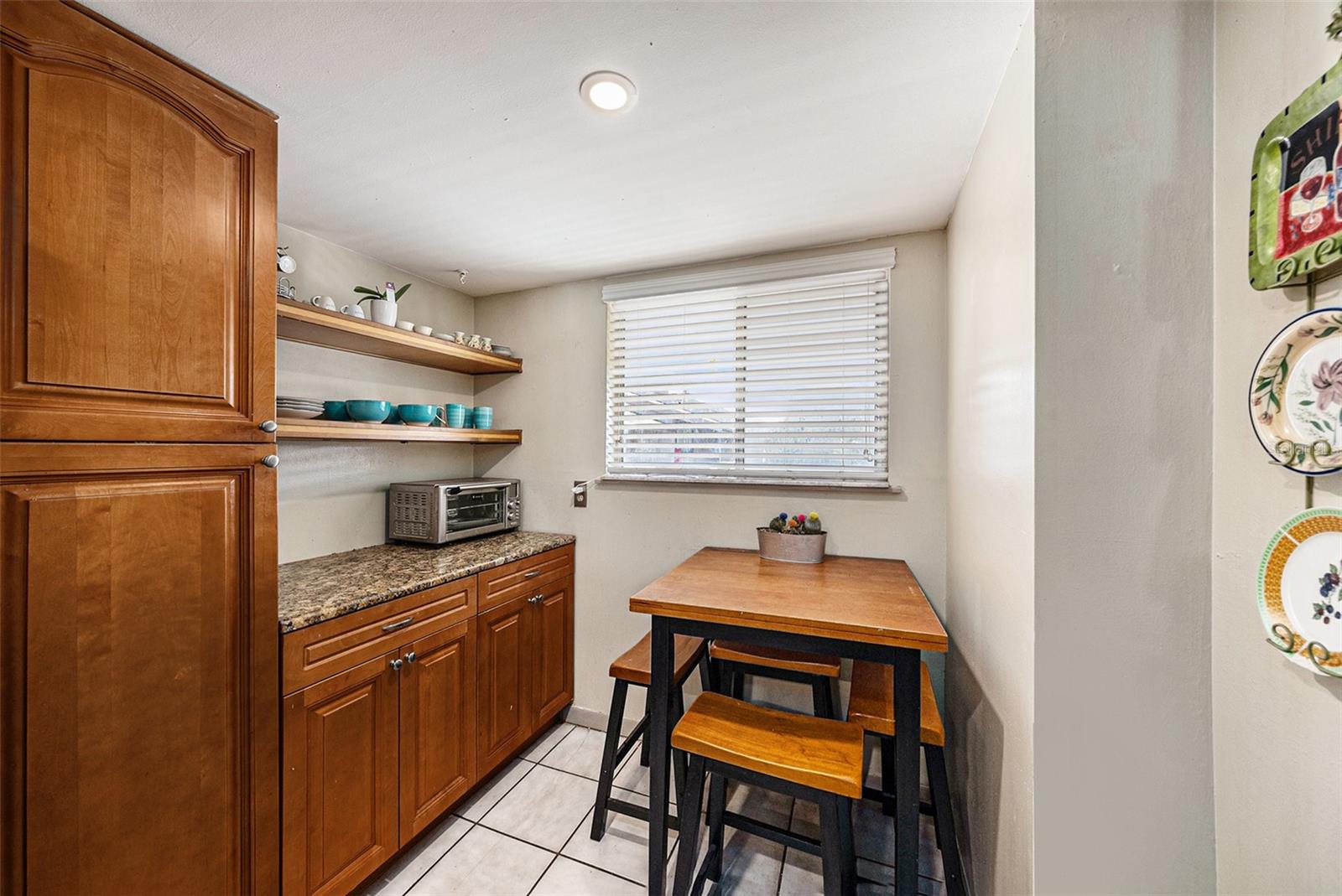 Open shelving and eat-in space in the kitchen.