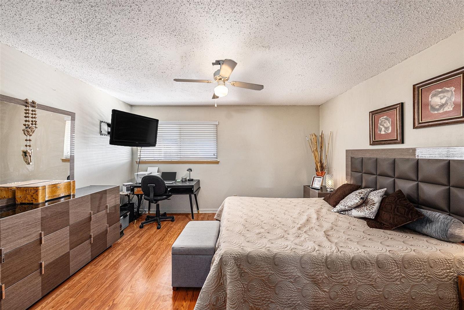 Wood look floors and ceiling fan.