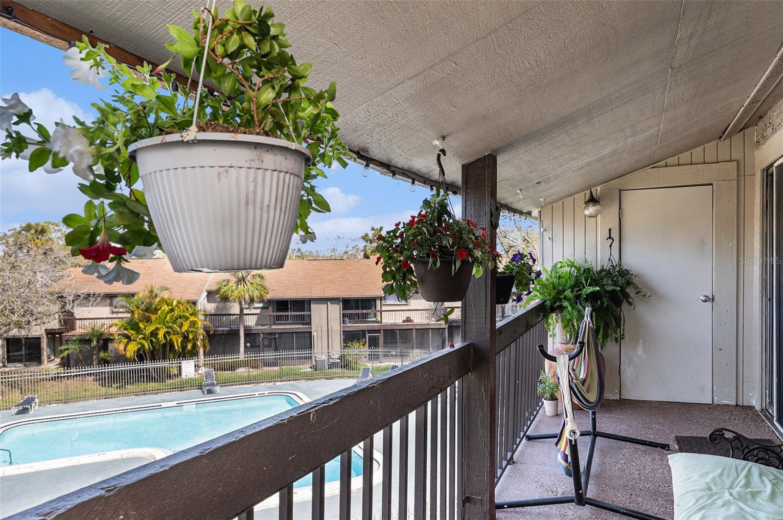 Relax on your covered balcony and enjoy views of the pool.