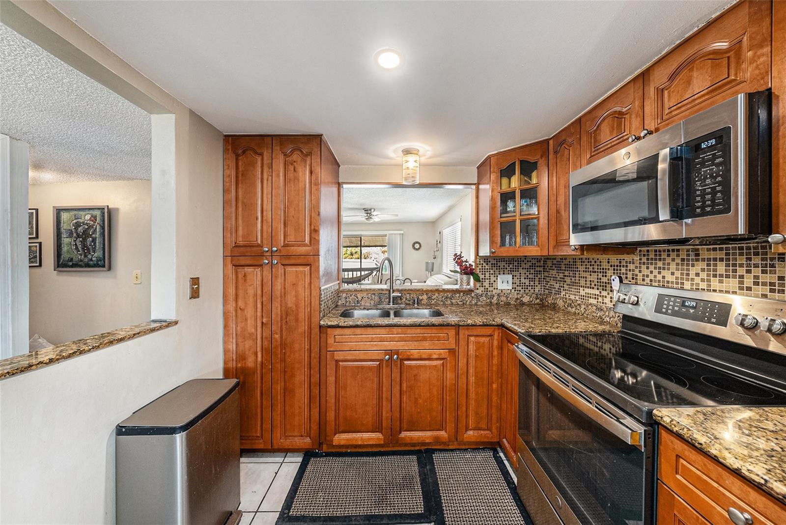 Granite countertops, stainless appliances, and opening to the dining and living areas.