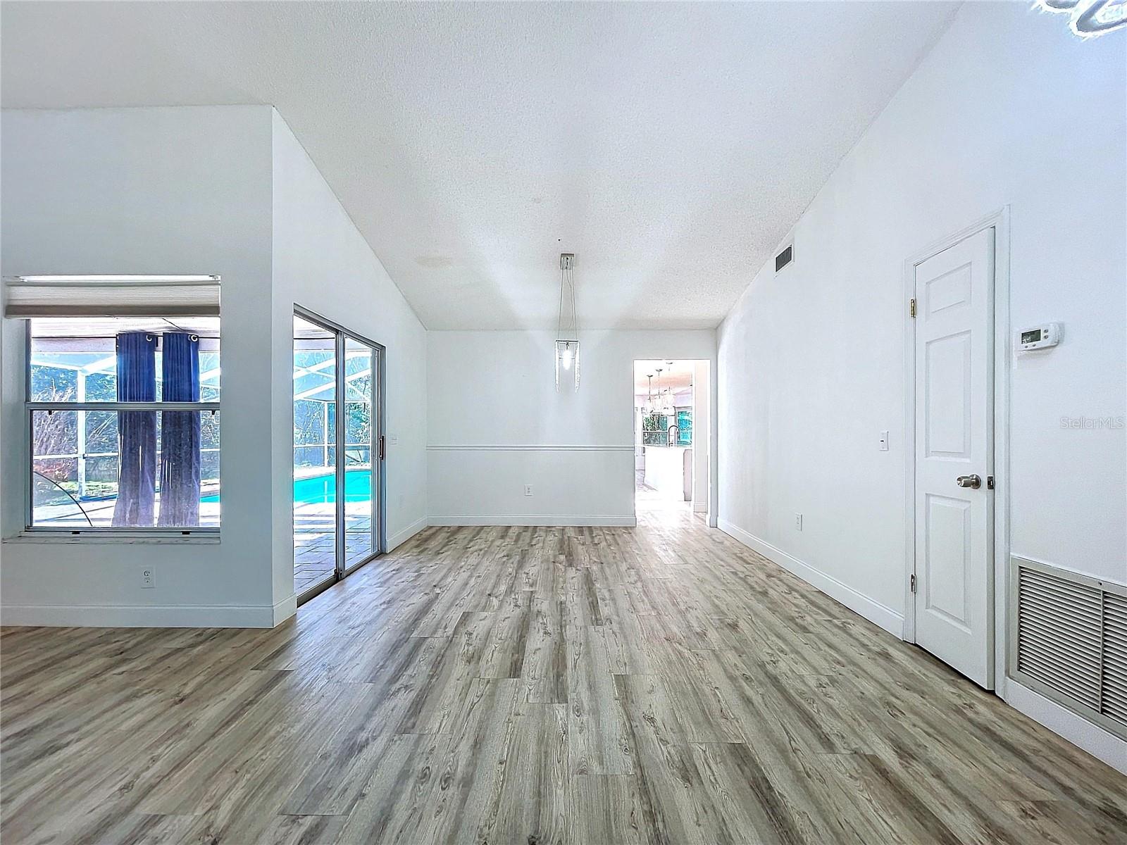 Formal dining leading facing kitchen