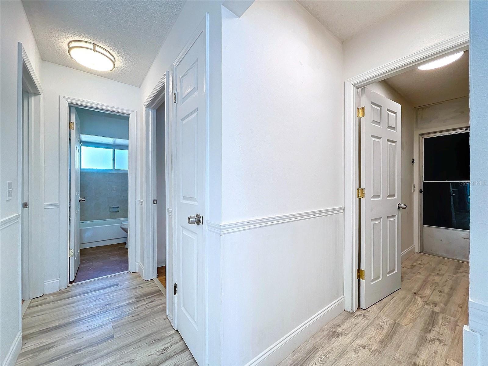 Hallway leading to main bath and to garage/laundry