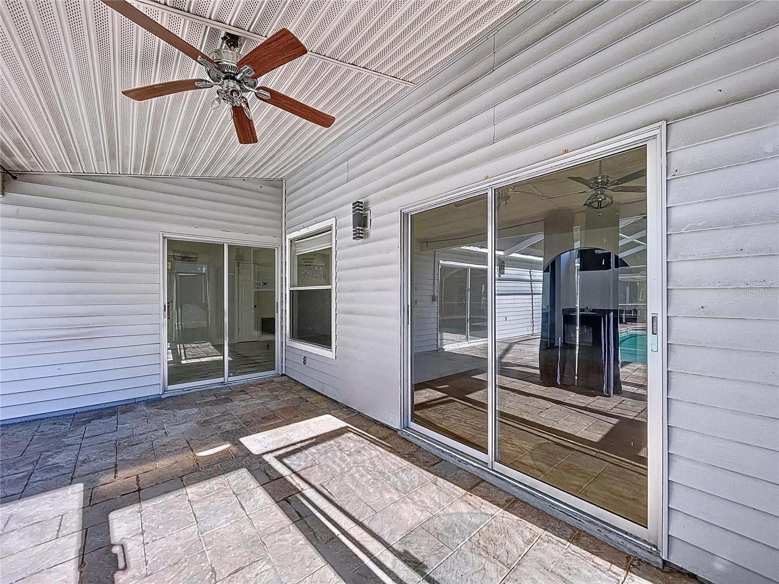 Lanai with slider leading to primary bedroom