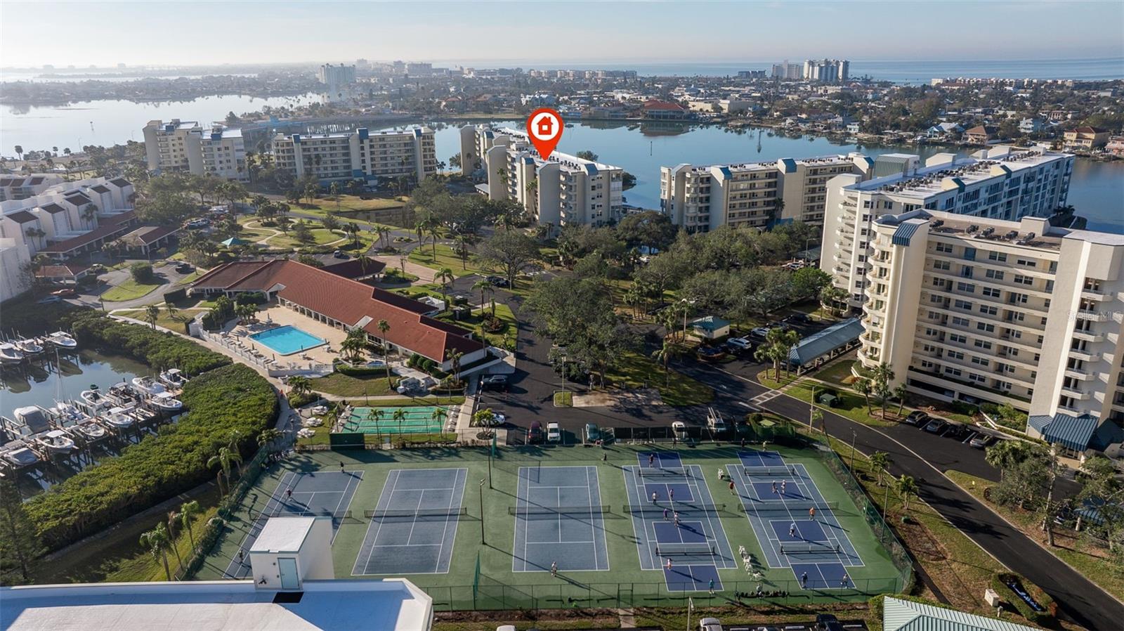 Aerial of the sprawling Clubhouse, Main Pool, Tennis & Pickelball Cpourts, Shuffleboard and Barbeque Area!