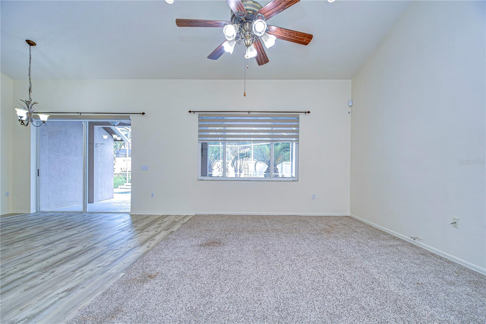 Living room with pool access and plenty of light.