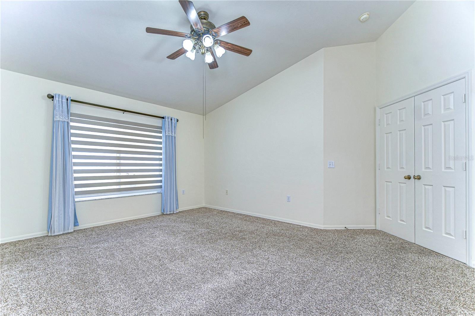 Large primary room with plush carpeting and natural light