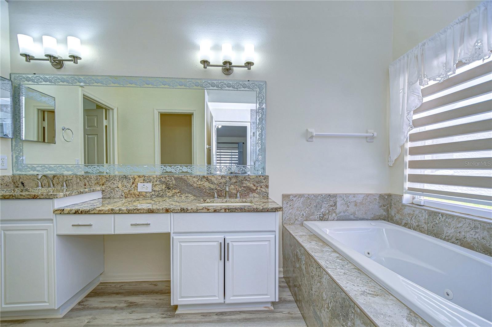 Indulge in luxury with spa-like serenity and opulent granite countertops in the primary bathroom.