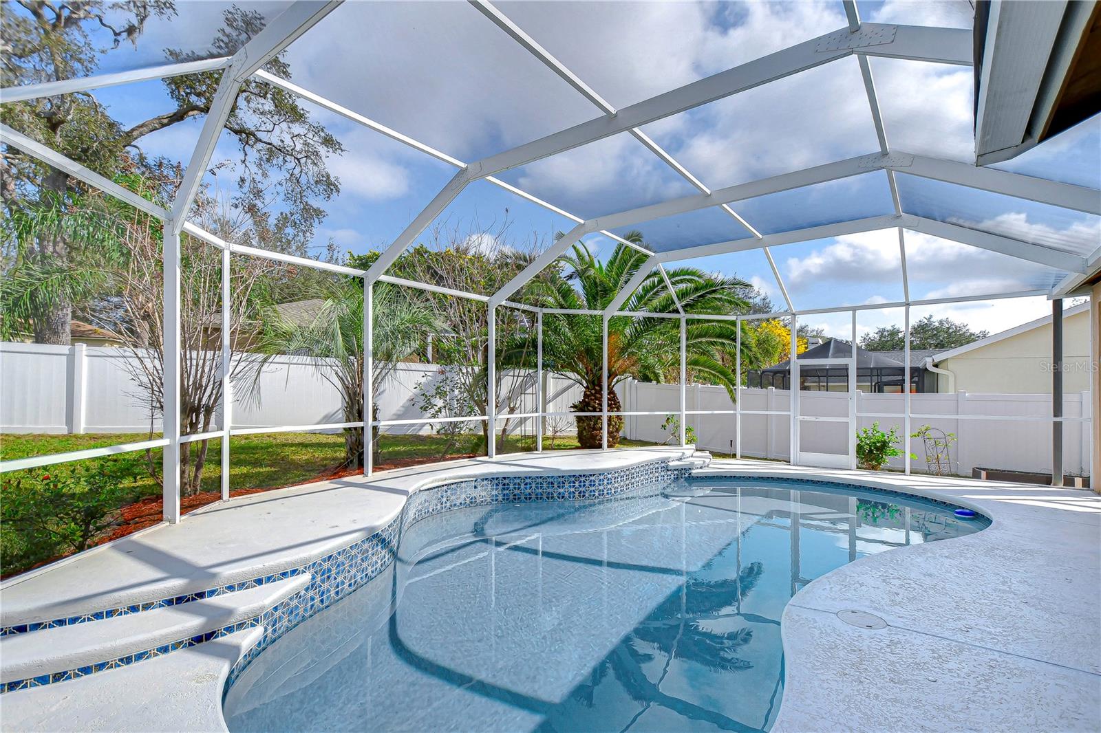 Enjoy endless sunny days by your private screened pool.