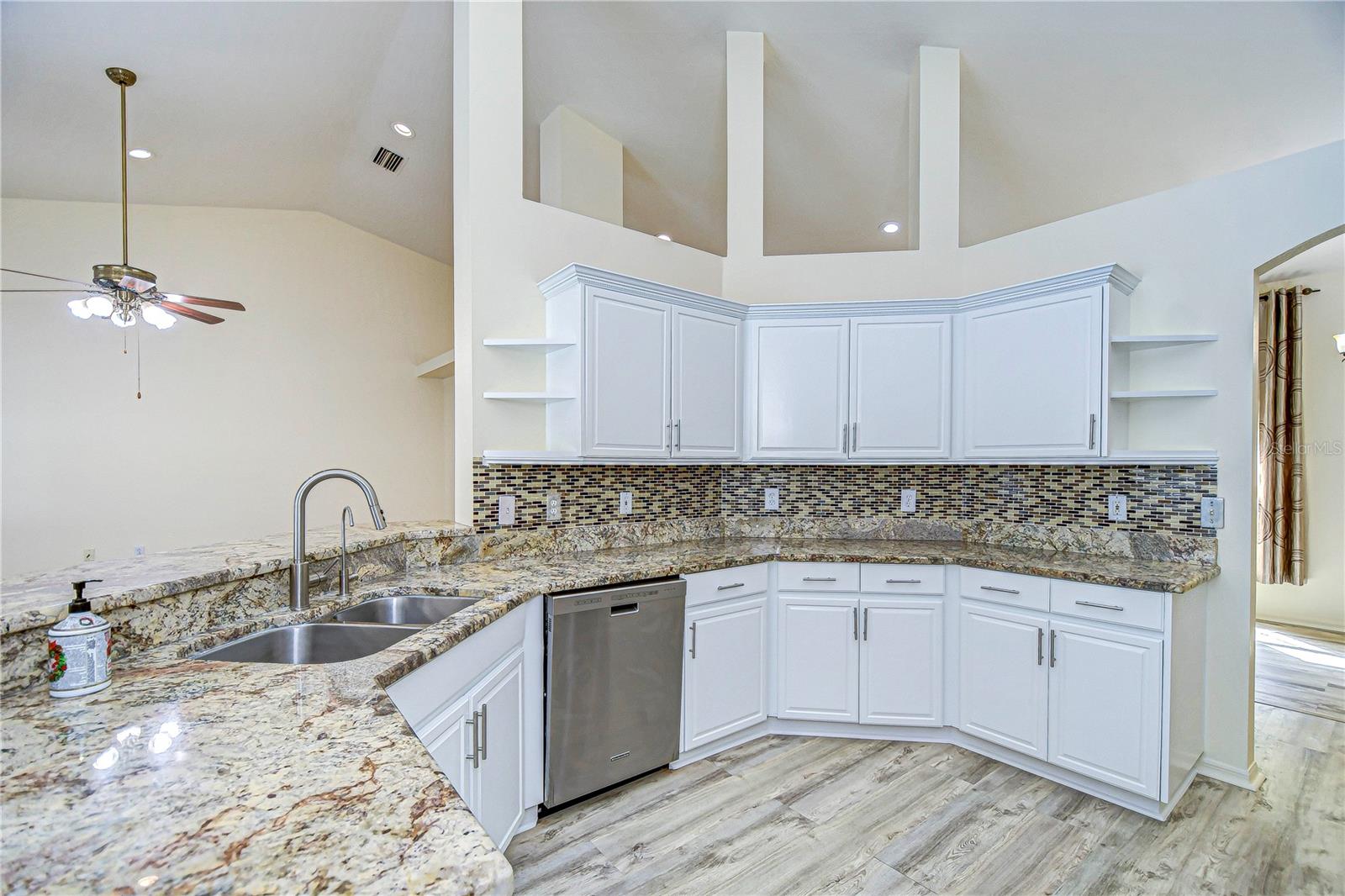 Spacious kitchen with stunning granite countertops and modern stainless steel appliances.