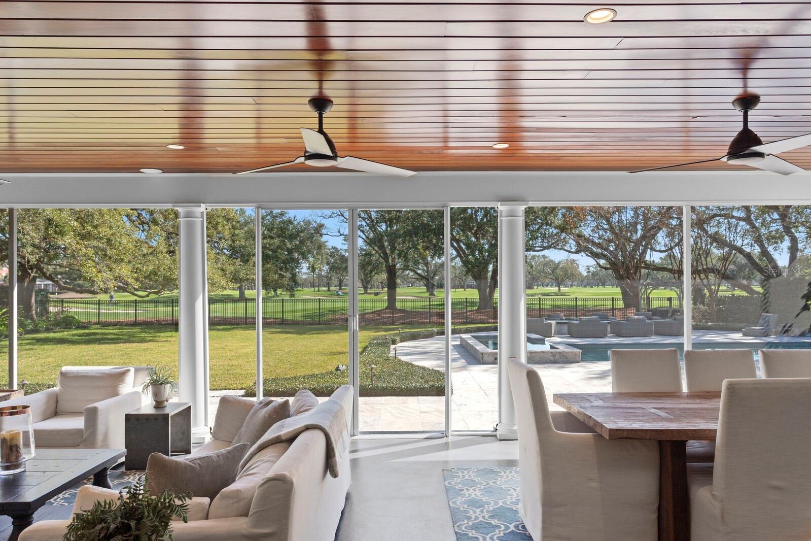 Enormous screened in lanai with seating and dining areas.